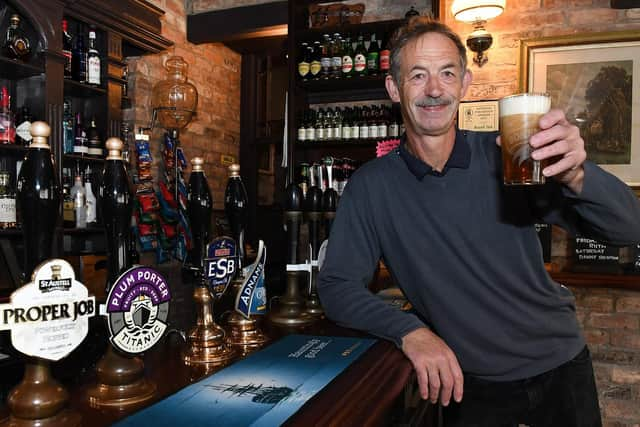 Manager Mark Pennington raises a glass to toast the pub's success