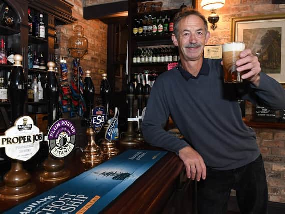 Manager Mark Pennington raises a glass to toast the pub's success