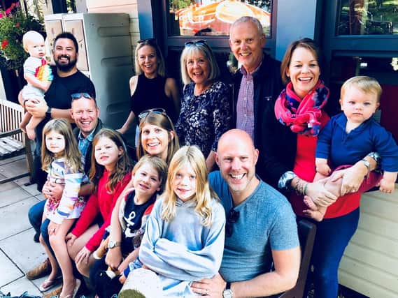 Andrew with his wife Vicki Redpath (at the back) and extended family including children and grandchildren.