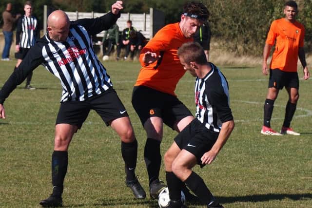 Edgehill skipper Joe Gallagher grapples with two Sherburn opponents. Picture by Steve Lilly.
