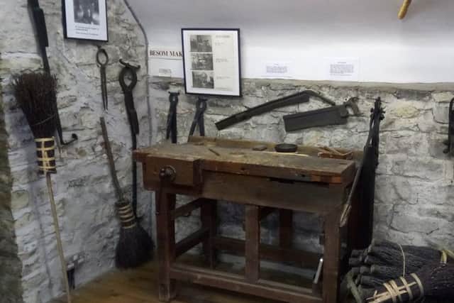 The display of besoms and the equipment used to make them at Beck Isle Museum, Pickering.