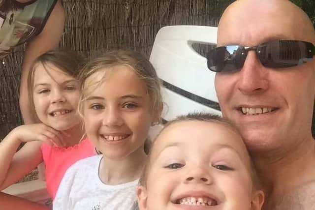 Damian with some of his children at a family holiday