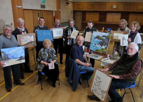A U3A art class proudly show off their work. File image.