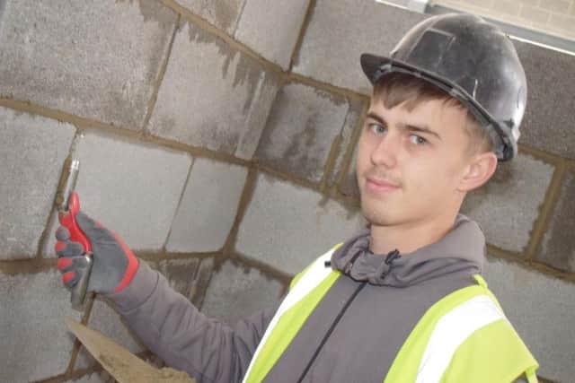 Nineteen-year-old Kai Ellis pointing the brickwork in the new Engineering & Construction Centre.
