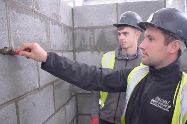 Kyle May demonstrating pointing to Apprentice, Kai Ellis.