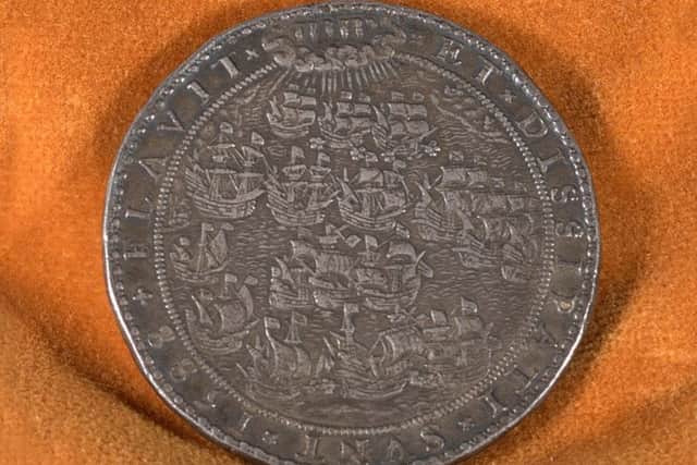 Armada Medal. The phrase Jehovah blew with His winds, and they were scattered is said to have its origins from the Latin inscription Flavit Jehovah et Dissipati Sunt on the medal.