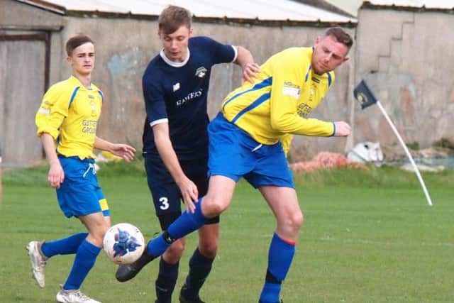 Cayton Athletic (dark blue kit) take on Eastfield Town