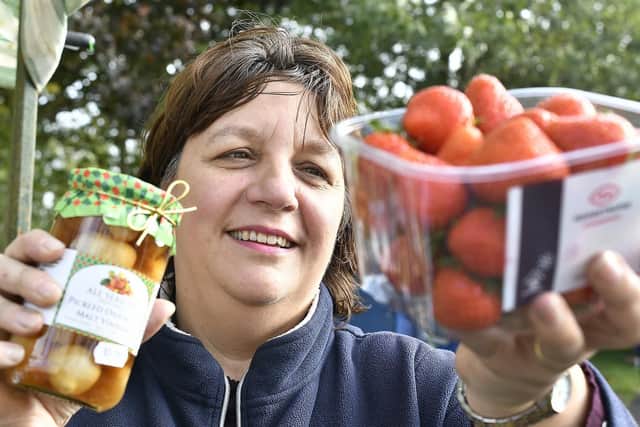 Kay Waddington of Filey's All Seasons store displaying her stock.