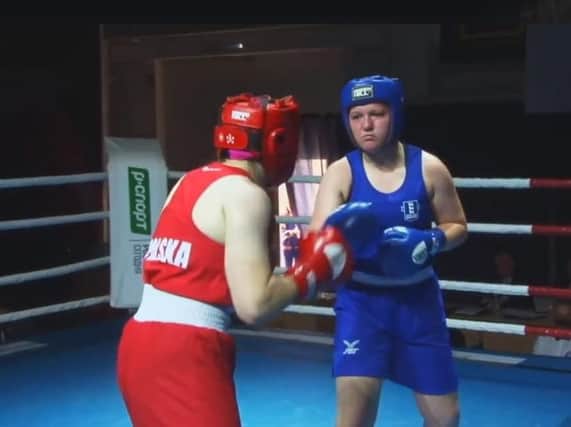 Emily Asquith (blue vest) in action in this afternoon's final in Russia.