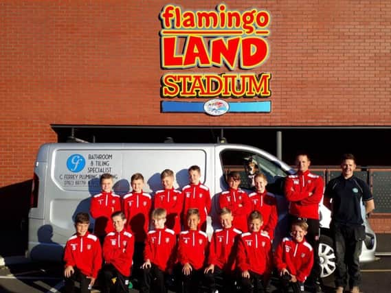 Scarborough Athletic Under-11s show off their new tracksuits, which have been bought by Chris Ferrey, back right, of Chris Ferrey Plumbing & Heating