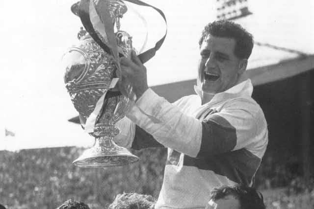 Wakefield Trinity's Derek Turner holds aloft the Challenge Cup