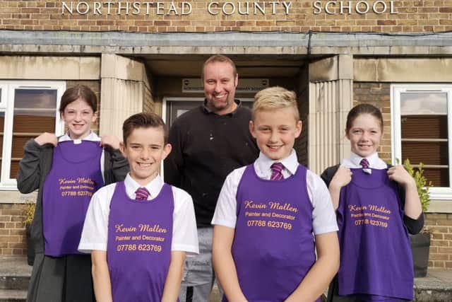 Sponsor Kevin Mallen with Northstead Primary School pupils, complete with the new vests.