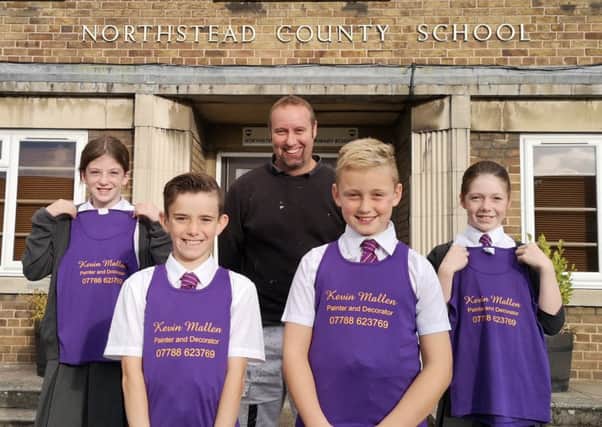 Sponsor Kevin Mallen with Northstead Primary School pupils, complete with the new vests.