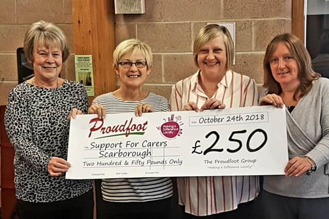 Support For Carers Scarborough representatives receive a £250 cheque.