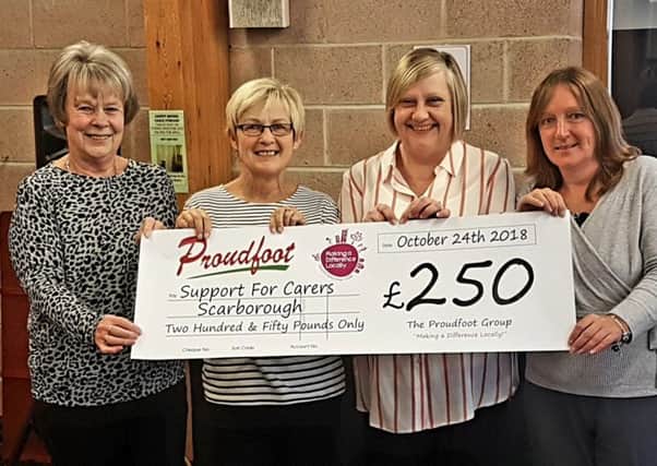 Support For Carers Scarborough representatives receive a Â£250 cheque.