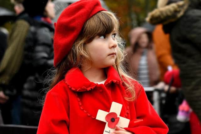 A girl holds a cross at today's service at Oliver's Mount
Picture: Richard Ponter