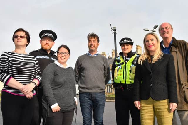 The new CCTV cameras at the roundabout in Pickering with members of the Ryedale Cameras In Action executive.