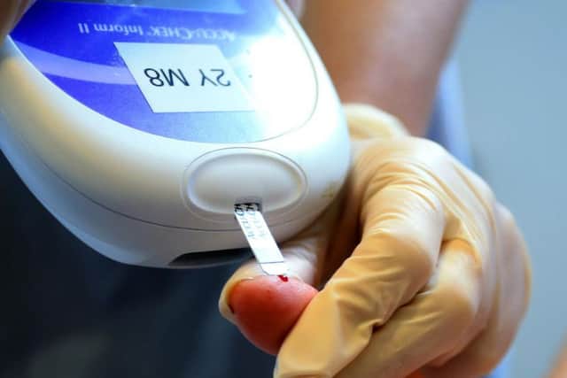 A nurse giving a patient a diabetes test