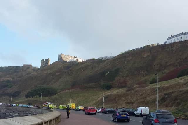 Several emergency service vehicles are at the scene.