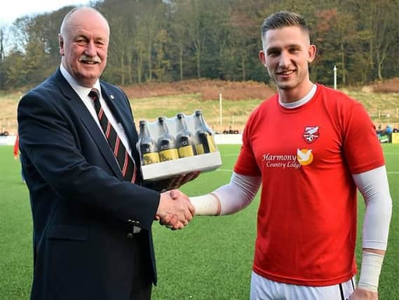 Boro's Tommy Taylor receives the player of the month award from chairman Trevor Bull