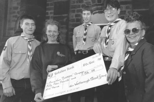 Venture Scouts, from left, Roy Dahl, Ben Smaller and Mathew Price with Bonnie Purchon, right, presented a cheque to Sue Balmford, of Scarborough and District Search and Rescue, for the Super Dog appeal in December 1995.