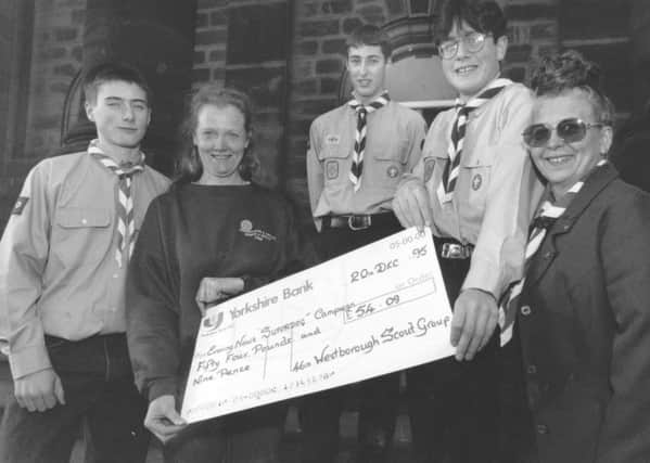 Venture Scouts, from left, Roy Dahl, Ben Smaller and Mathew Price with Bonnie Purchon, right, presented a cheque to Sue Balmford, of Scarborough and District Search and Rescue, for the Super Dog appeal in December 1995.