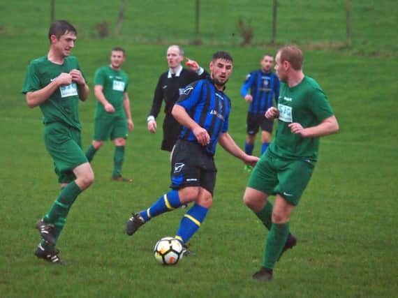 Jack Hakings battles for the ball in Newlands' win over Slingsby. Pictures by Steve Lilly.