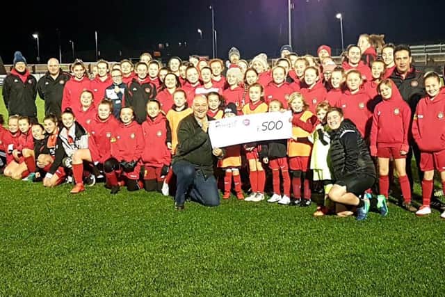 Scarborough Ladies FC, which currently has more than 130 girls registered with the club, receives a cheque for £500 from Proudfoot.