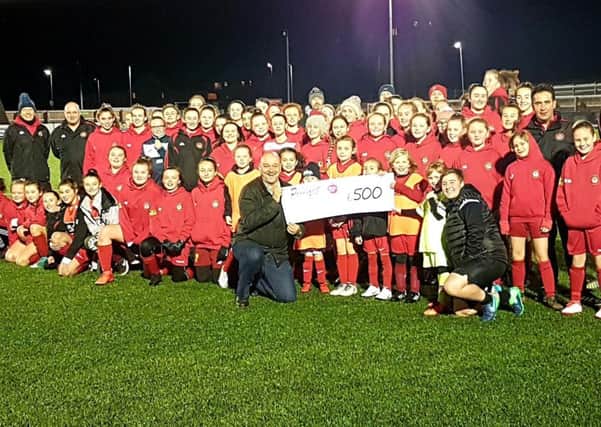 Scarborough Ladies FC, which currently has more than 130 girls registered with the club, receives a cheque for Â£500 from Proudfoot.