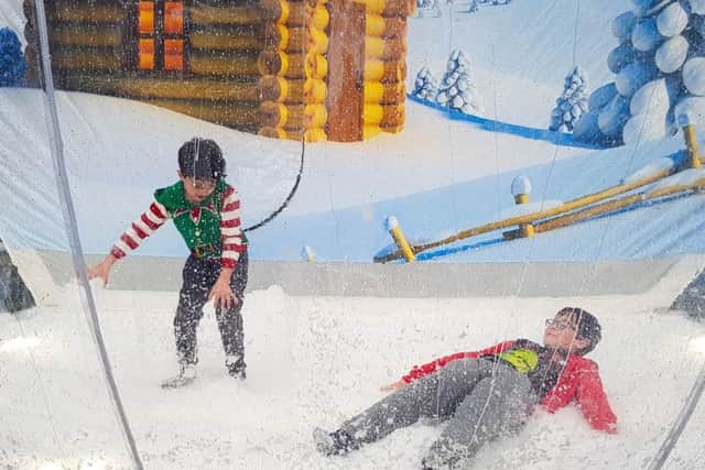 Children have fun in the giant snow globe during the Helmsley festivities.