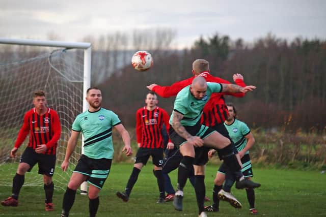 West Pier and Itis Itis battle for a header. Picture by Steve Lilly.