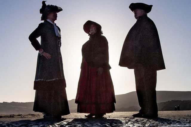 Pam Harrison, Kieth Harrison, dressed as a traditional town crier and Suzanne Dekker. Picture: Charlotte Graham.