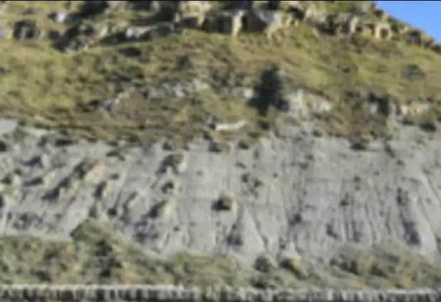 A man sustained leg and arm injuries falling down the castle headland