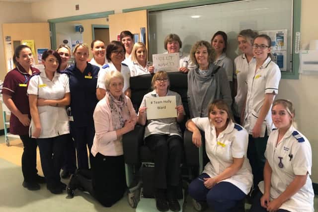 Staff on Holly Ward with the donation (therapy assistant Gail Dawes is centre in the chair).