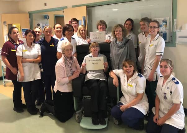 Staff on Holly Ward with the donation (therapy assistant Gail Dawes is centre in the chair).