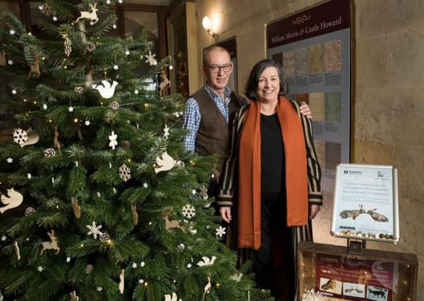 Mr and Mrs Howard stand next to the charity Christmas tree. Photograph taken by Andy Bulmer.