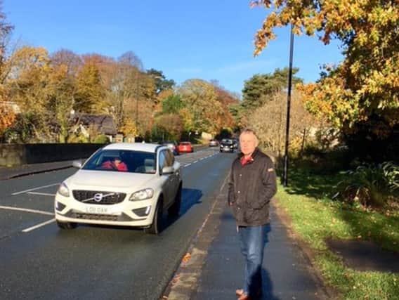 County Councillor Derek Bastiman at the site of the proposed traffic island