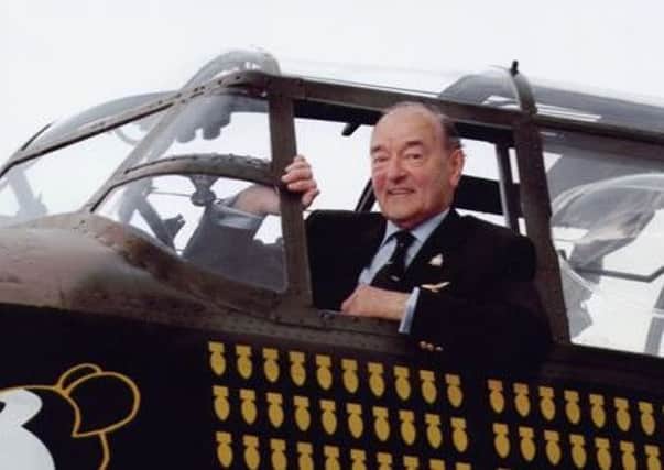 Flight Lieutenant Donald Briggs in the cockpit of a Lancaster bomber.