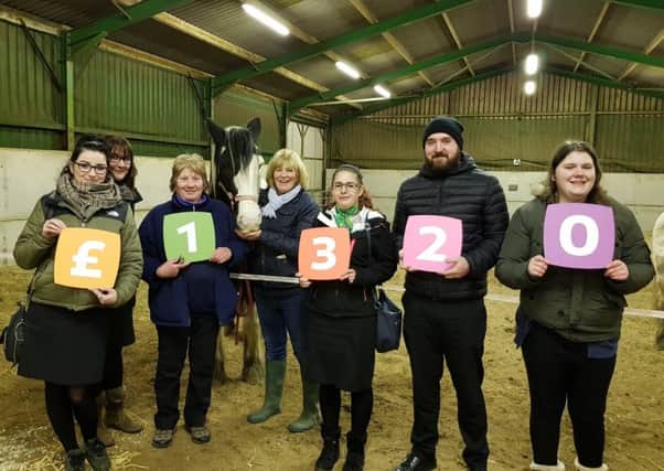 Yorkshire Building Society colleagues present the donation to Priory View Riding for the Disabled Association.