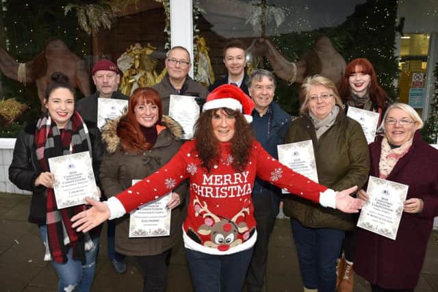 Janet Jefferson presents the Christmas Business window competition winners. Cloe Smith, Dave Binns, Amy Crowther, Phil Cook, Chris Golder, Tony Stevens, April Fletcher ,Meg Watts and Elaine Truman. Picture: Richard Ponter
