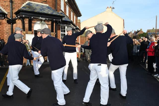 The dancers wear navy ganseys, white trousers and caps for their performances around the village.