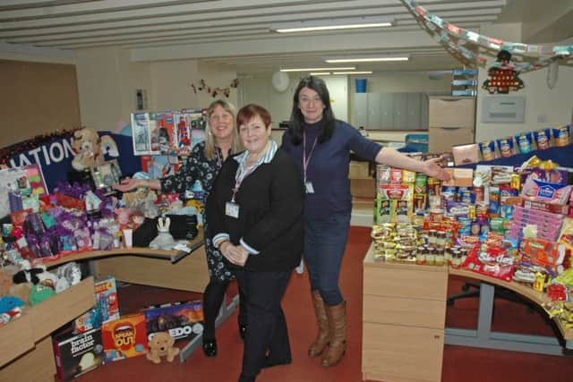 The councils Customer First team members with some of the donated gifts and food.