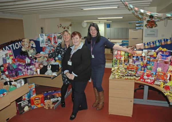 The councils Customer First team members with some of the donated gifts and food.
