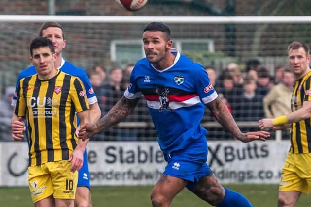 Michael Coulson watches on as former Boro man Leon Scott clears. Pictures by Brian Murfield