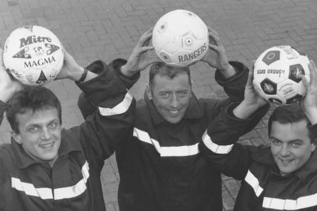 John Mitchell, Tommy Vaughan, and Mick Rivers with three signed footballs and a signed cricket bat put up for auction at Scarborough Fire Station in aid of the Martin MS Appeal and local charities.