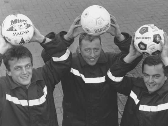 John Mitchell, Tommy Vaughan, and Mick Rivers with three signed footballs and a signed cricket bat put up for auction at Scarborough Fire Station in aid of the Martin MS Appeal and local charities.