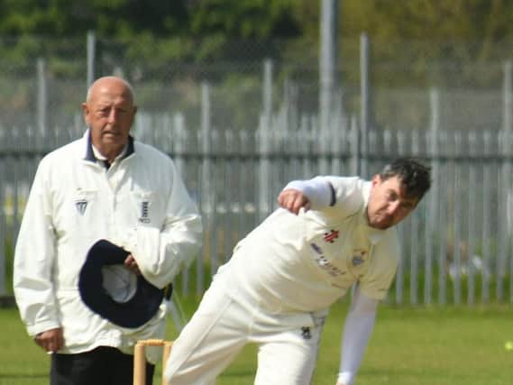 Umpire Mick Stubbs looks on as Brid's Pete Bowtell bowls