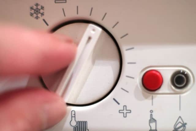 A thermostat dial controlling the temperature of a boiler.