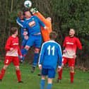 Cayton's keeper punches clear under pressure from Ayton skipper Ian Laing. Picture by Steve Lilly.