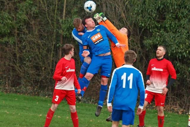 Cayton's keeper punches clear under pressure from Ayton skipper Ian Laing. Picture by Steve Lilly.